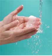 Running Travel Hand Soap under water to dissolve it