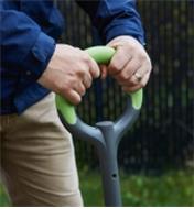 Close up of man gripping the handle of the Radius Ergonomic Stainless-Steel Digging Fork
