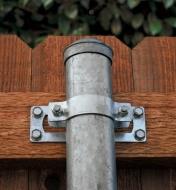 Example of in-line bracket securing a steel post to a wooden fence rail