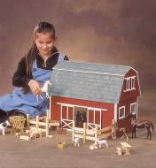 A child plays with the assembled barn and farmyard animals