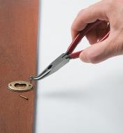 Using Offset Pliers to place pins in an escutcheon for mounting