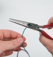 Using the straight pliers to cut wire