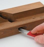 Using the plane maker’s float to smooth the edge of a wedge mortise on a wooden plane