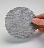 Holding a sanding disc to show mesh texture