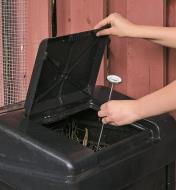 Inserting the Compost Thermometer in a compost bin