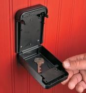 Wall-Mount Lockbox attached to a wall, opened to show a key inside