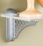 Colonial Tumbled Nickel Adjustable Bracket mounted on a wall with a glass shelf