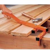 Using the BoWrench Deck Tool to position lumber on a deck