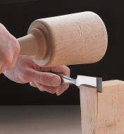 Splitting wood with a batoning chisel and mallet