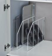 Baking pans separated between cabinet dividers installed in a cabinet