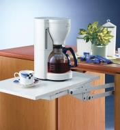 A swing-up shelf made with the Appliance Lift in the in-use position, holding a coffeemaker