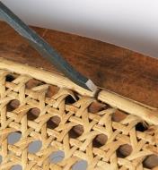 Using the Caning Chisel to remove reed spline from a seat