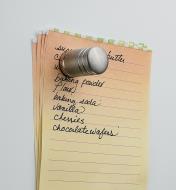 Example of customized magnet holding a shopping list on a fridge