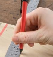 Marking a line in wood against a ruler using the Carpenter's Retractable Lead Pencil