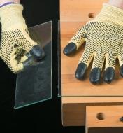 A person wearing Cut-Resistant Gloves separates two pieces of cut glass