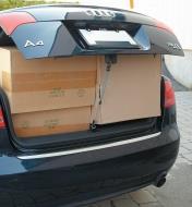 Adjustable Bungee used to tie down an open car trunk holding a load of boxes