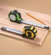 Both Auto-Lock Write-On Measuring Tapes partially extended, sitting on a board