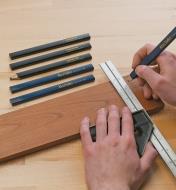 Marking a board using a combination square and a carpenter's pencil