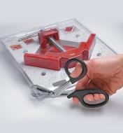 Cutting off the corner of a clamshell package with Clamshell Scissors