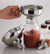 Canning Funnel held over a Mason jar being filled with sauce
