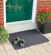 Large Cape Cod Doormat placed outside a front door with a pair of shoes on it