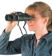 A woman looks through a pair of Binoculars