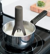 Auto-Stirrer stirring sauce in a pot on a stove
