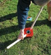 Installing the ground screw by twisting it into the ground using two rods
