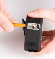 Sharpening a pencil in the built-in pencil sharpener