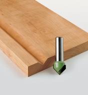 Groove Bit next to a board with a V-groove cut into it