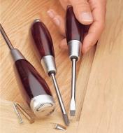Holding one of the Heavy-Duty Screwdrivers with other sizes lying next to it