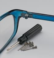 Screwdriver and screws next to a pair of glasses