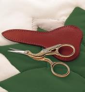 Stork Scissors and Sheath lying on a quilt