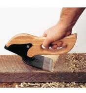 Using the Enxó to scrape a piece of lumber