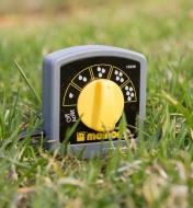 Electronic Water Timer Moisture Sensor inserted in a lawn
