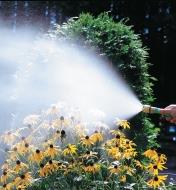 Watering flowers in a garden using the fogging nozzle