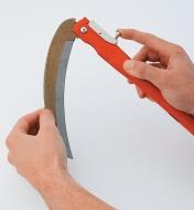 Folding Sickle blade being folded into handle