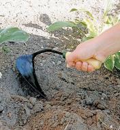Short-Handled Ho-Mi Digger being used for digging in soil