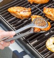 Using Grill Fry Tongs to pick up a chicken breast on a barbecue 