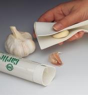 Peeling a garlic clove with the garlic peeling mat