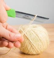 Using a paring knife to cut twine