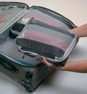 Placing filled Expandable Packing Cubes in a suitcase