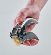 Pressing the handles on the Garlic Press to mince garlic