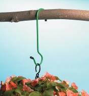 An extension S-hook hanging a planter on a branch