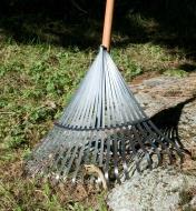 Using the 20-Tine Flexible Rake to rake leaves on uneven terrain