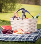 Handwoven Basket Tote on a picnic blanket, holding water and food items