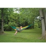 A woman relaxes in a hammock held between two trees by the Hammock Tree Straps