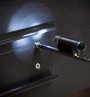 Tool light secured to screwdriver shaft provides light for installing screw in a dark area