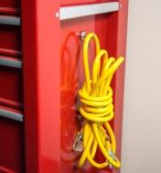 Extension cord hanging on a magnet-mounted hook attached to a tool chest