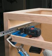 Using a mounting bracket to install a slide in a face-frame cabinet